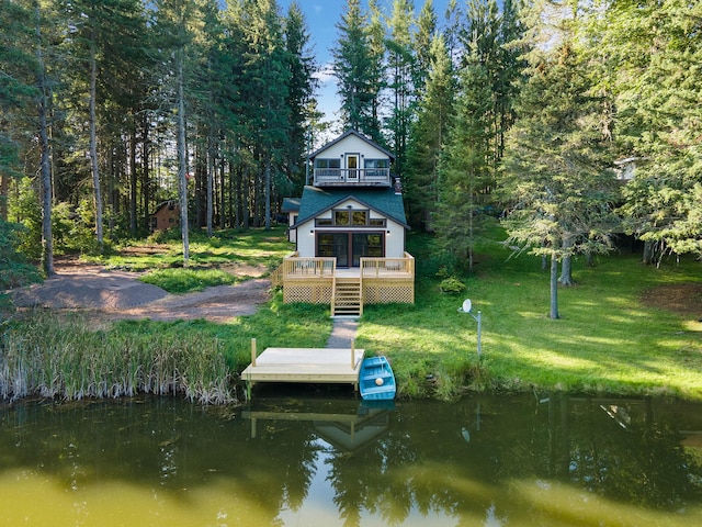 dock area with a deck with water view and a lawn