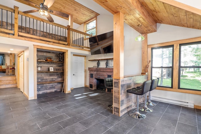 living room featuring a baseboard radiator, built in features, wood ceiling, and a healthy amount of sunlight