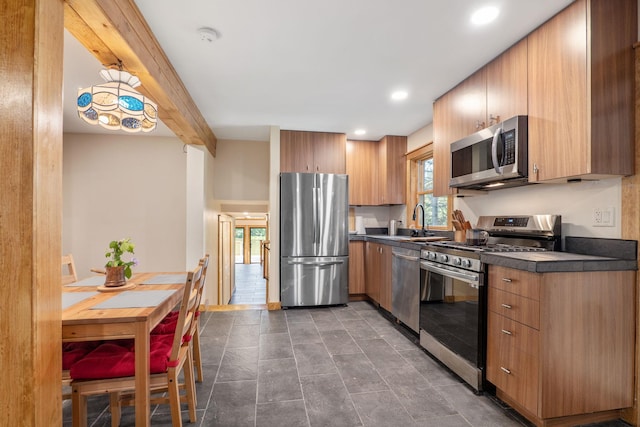 kitchen with sink, stainless steel appliances, and beamed ceiling