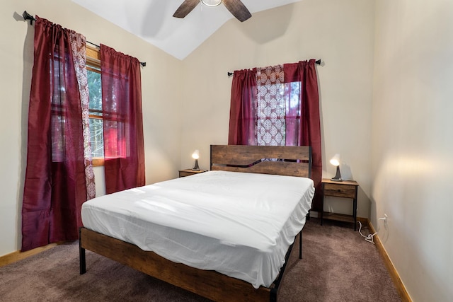 bedroom with ceiling fan, vaulted ceiling, and carpet floors