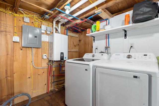 laundry room featuring electric panel, dark hardwood / wood-style floors, water heater, and washing machine and clothes dryer