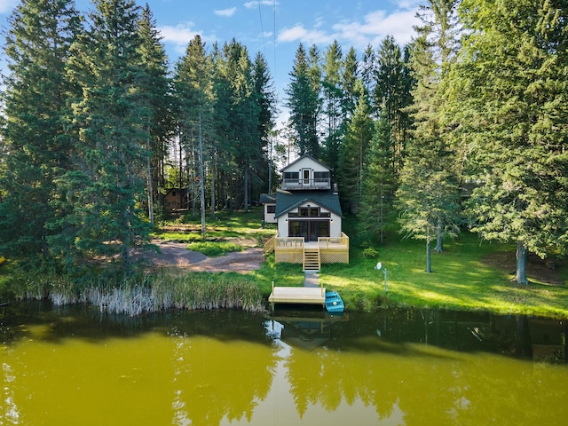 view of dock featuring a water view and a lawn