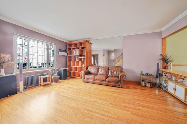 living room with light hardwood / wood-style floors, radiator heating unit, and ornamental molding