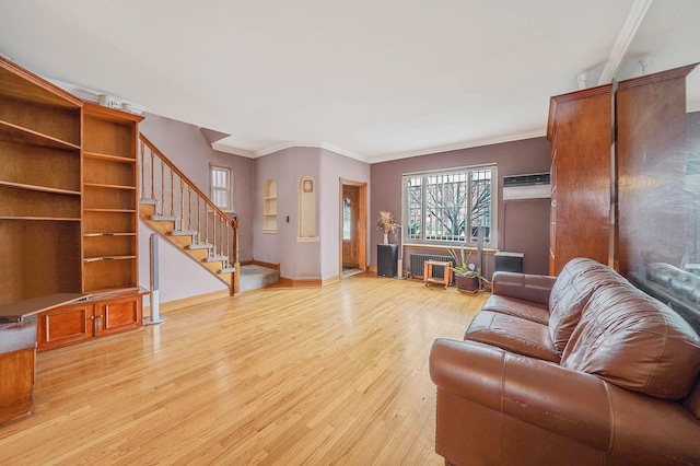 living room featuring a wall unit AC, radiator heating unit, ornamental molding, and light hardwood / wood-style floors