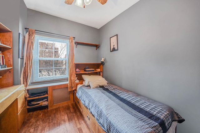 bedroom with ceiling fan and dark hardwood / wood-style flooring