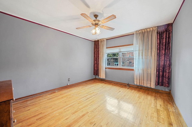 unfurnished room featuring ceiling fan, light hardwood / wood-style flooring, and crown molding