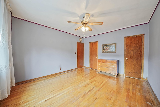 unfurnished bedroom featuring light wood-type flooring, ceiling fan, and ornamental molding