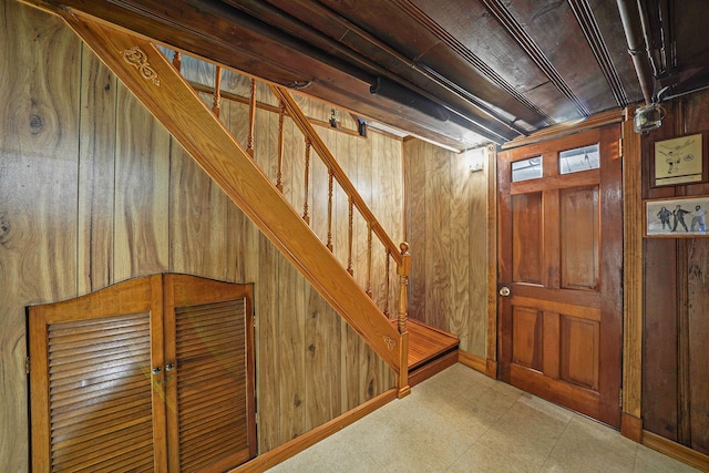 basement featuring wood walls