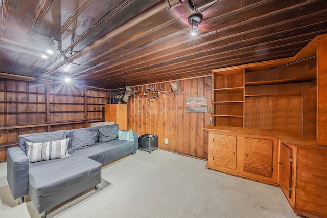 interior space featuring light colored carpet and wooden walls