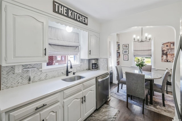 kitchen featuring stainless steel appliances, tasteful backsplash, hanging light fixtures, white cabinets, and sink