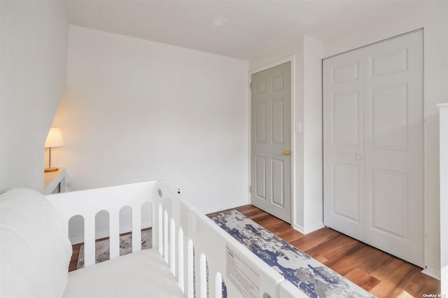 bedroom featuring hardwood / wood-style flooring and a closet