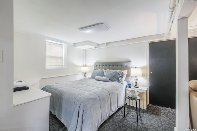 bedroom with dark colored carpet