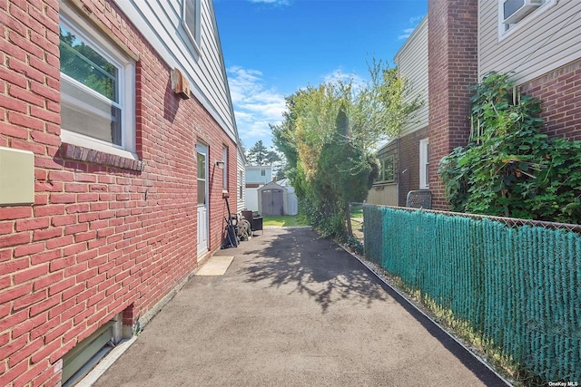 view of side of home with a storage shed