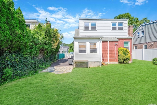 rear view of house with a yard