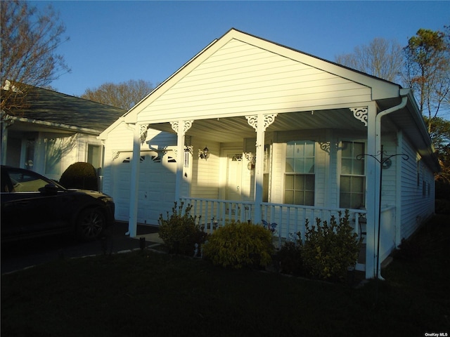 exterior space featuring a porch and a garage