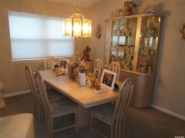 carpeted dining area featuring a chandelier