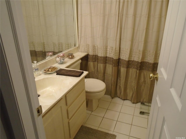 bathroom featuring toilet, tile patterned flooring, and vanity