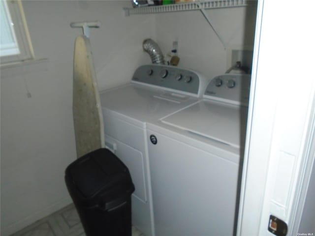 clothes washing area with separate washer and dryer