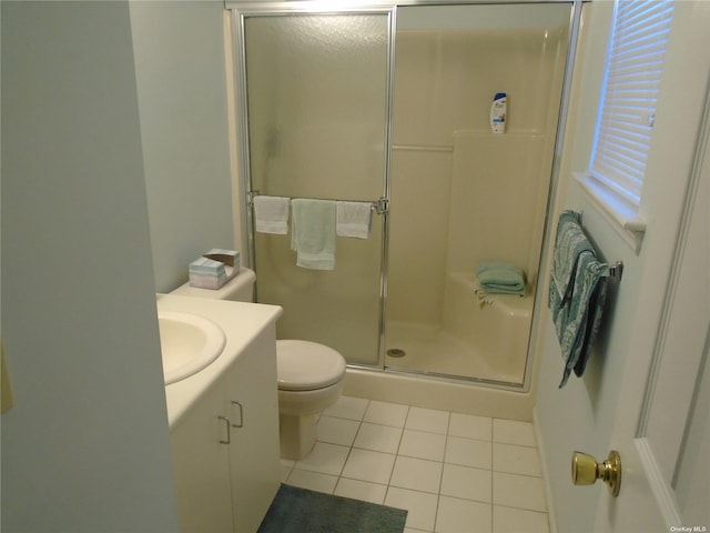 bathroom featuring tile patterned floors, toilet, an enclosed shower, and vanity