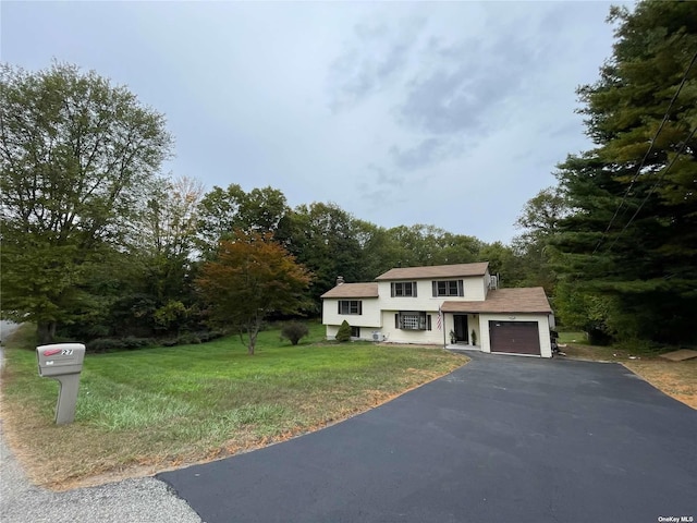 view of front of house with a front lawn and a garage