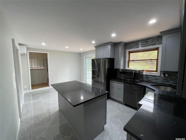 kitchen with dishwashing machine, black fridge with ice dispenser, gray cabinets, and a kitchen island