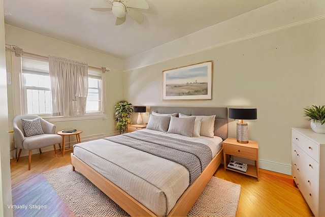 bedroom with light hardwood / wood-style flooring and ceiling fan