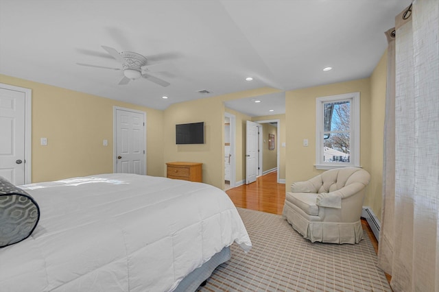 bedroom with a baseboard heating unit and ceiling fan