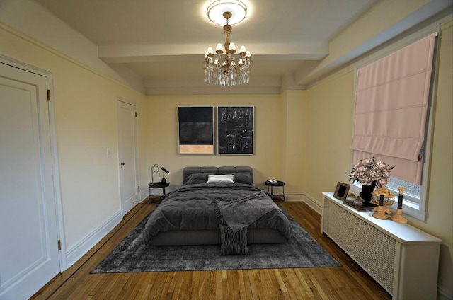 bedroom with beam ceiling, radiator, and dark hardwood / wood-style floors