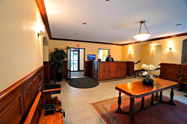 interior space with light tile patterned floors and ornamental molding