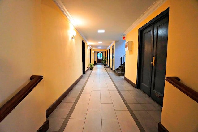 hall with light tile patterned floors and crown molding