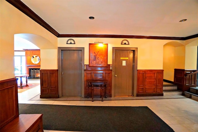 kitchen featuring light tile patterned flooring and crown molding