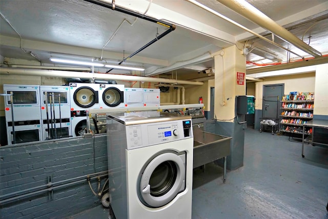 laundry room featuring washing machine and dryer and stacked washer / drying machine