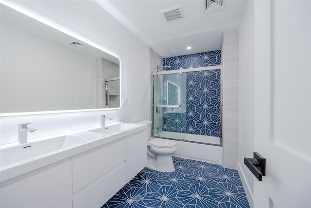 full bathroom featuring toilet, tile patterned flooring, enclosed tub / shower combo, and vanity