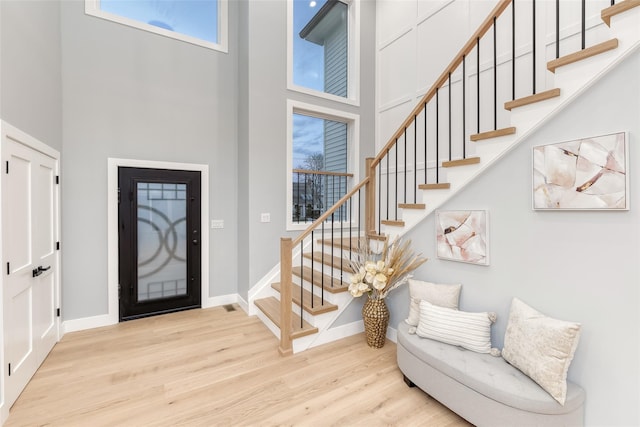 entrance foyer with a high ceiling and light wood-type flooring