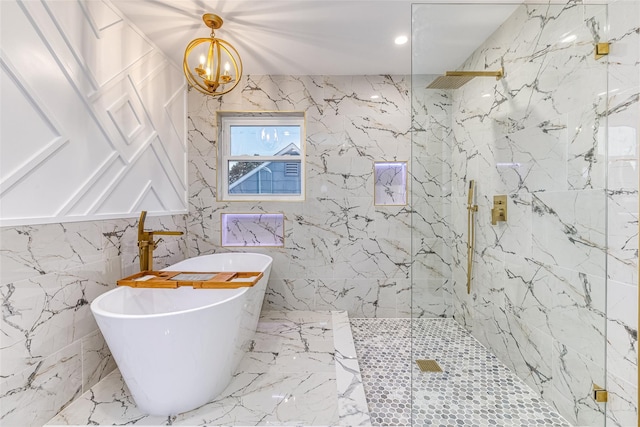 bathroom with independent shower and bath and an inviting chandelier