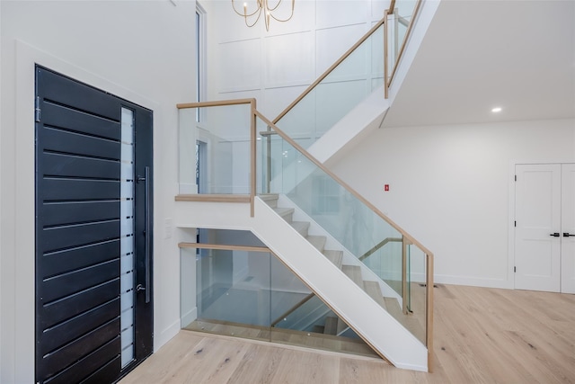 stairway featuring a chandelier and hardwood / wood-style flooring