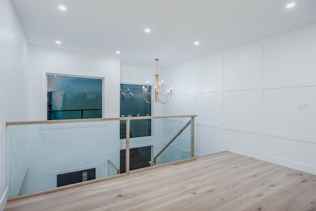 interior space featuring hardwood / wood-style floors and a notable chandelier