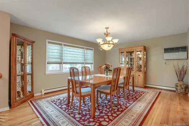 dining area featuring a baseboard radiator, light hardwood / wood-style flooring, a chandelier, and a wall mounted air conditioner