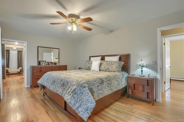 bedroom with ceiling fan, light hardwood / wood-style flooring, and baseboard heating