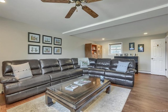 living room featuring ceiling fan, baseboard heating, and wood-type flooring