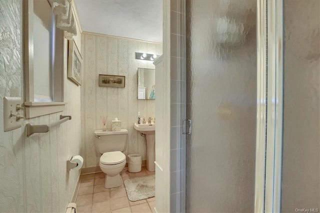 bathroom featuring walk in shower, sink, toilet, and tile patterned floors