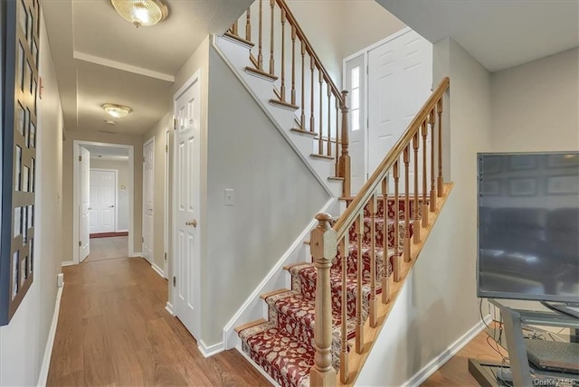 stairs featuring wood-type flooring