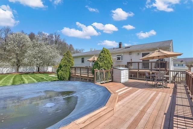 wooden terrace featuring a yard