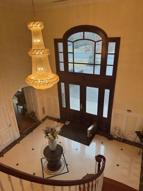 tiled foyer entrance featuring ornamental molding