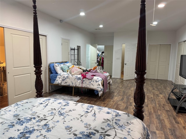 bedroom with dark hardwood / wood-style flooring