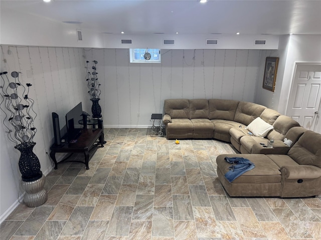 living room featuring wood walls