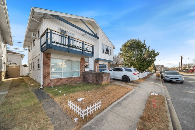 view of front of house featuring a balcony