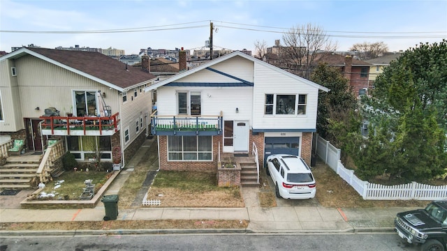 view of front of property featuring a balcony and a garage