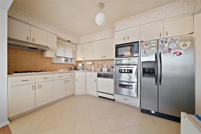 kitchen with white cabinetry, decorative backsplash, and stainless steel appliances