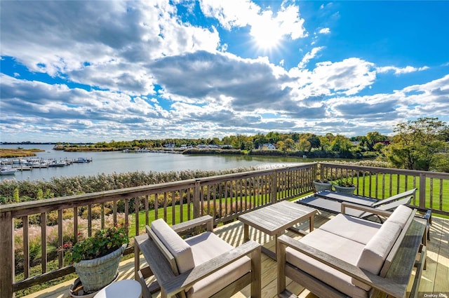 deck featuring a yard and a water view